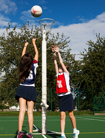 AusSport Scoreboards girls shooting netball into hoop