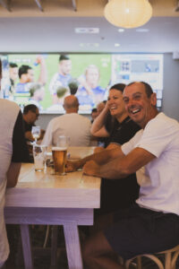AusSport Indoor Screen at pub with patrons in foreground